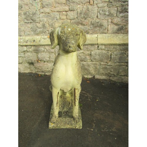 1053 - A weathered cast composition stone garden ornament in the form of a seated hound set on a rectangula... 