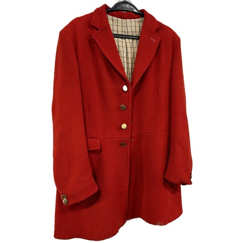 583 - A red wool hunting jacket, made by Saddle Master, a pair of black leather riding boots with wooden t... 