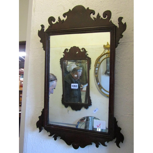 1353 - A small Georgian style wall mirror the walnut frame with fret carved outline, 68cm x 43cm