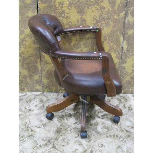 1269 - A reproduction swivel desk chair with horseshoe shaped button back