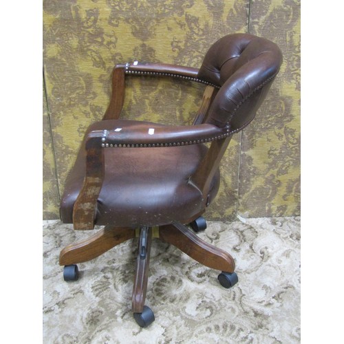 1269 - A reproduction swivel desk chair with horseshoe shaped button back