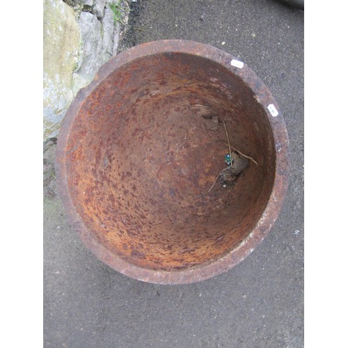 1017 - A weathered cast iron cauldron with simple flared rim raised on an associated stand, 45 cm (full hei... 