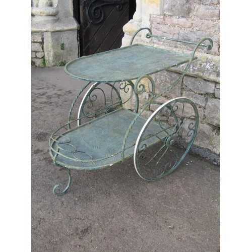 1023 - An ironwork two tier conservatory drinks trolley with simulated verdigris painted finish