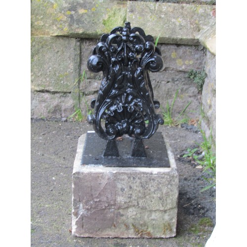 1026 - A cast iron black painted boot scraper with scrolled acanthus and shell detail set on a rectangular ... 