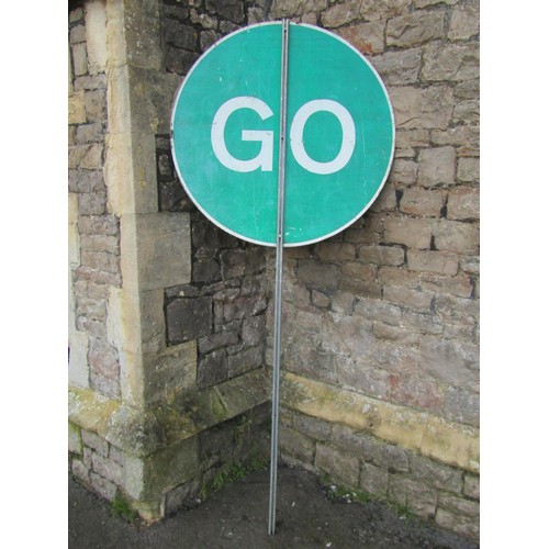 1038 - A painted metal Stop / Go lollipop traffic sign, 90 cm diameter