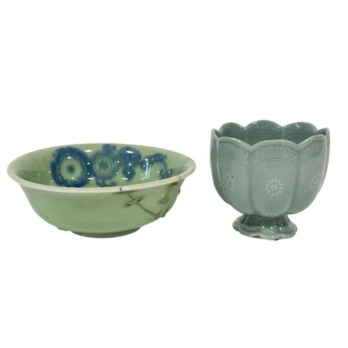 74 - An oriental celadon glazed bowl with floral detail together with a further lotus shape cup on a stan... 