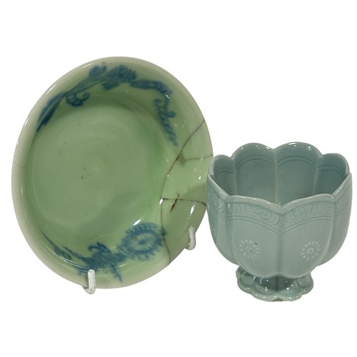 74 - An oriental celadon glazed bowl with floral detail together with a further lotus shape cup on a stan... 