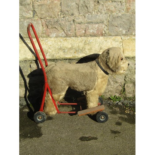 1060 - A Vintage Pedigree soft toy push-along dog, together with two rocking horses (af) (3)