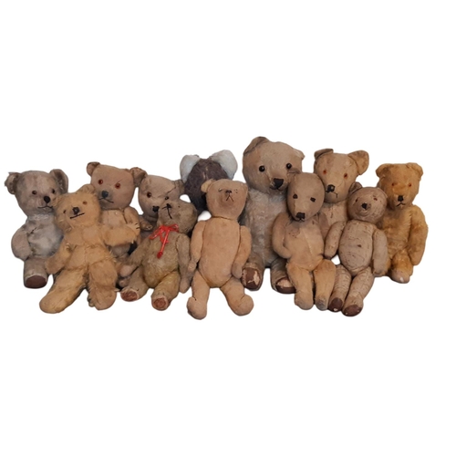 765 - A collection of 12 unsorted vintage teddy bears all playworn and most in need of restoration. Height... 