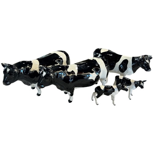 75 - Five Beswick porcelain Friesian cow figures to include a bull, two cows and two calves (5)