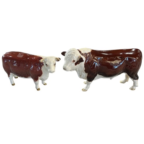 75A - Two Beswick porcelain Hereford cattle figures, bull and cow (2)