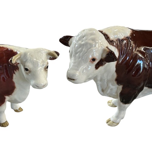 75A - Two Beswick porcelain Hereford cattle figures, bull and cow (2)