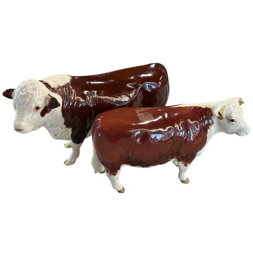 75A - Two Beswick porcelain Hereford cattle figures, bull and cow (2)