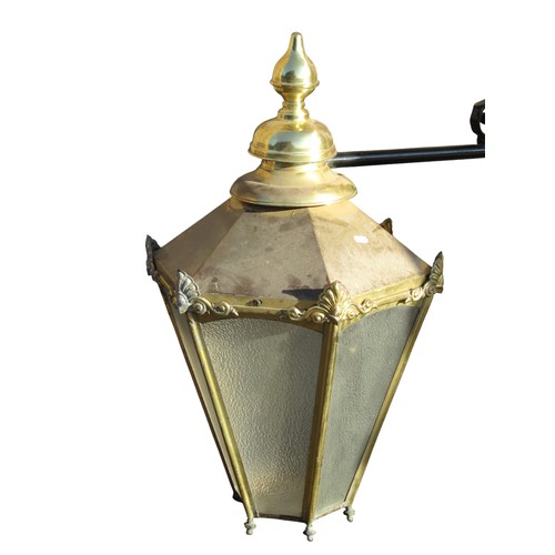 1037 - A large reproduction exterior lantern of hexagonal tapered form, with fixed adjoining wall bracket, ... 