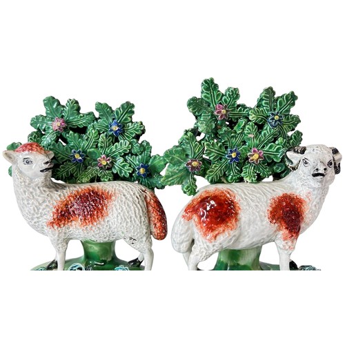 33 - A pair of late 18th century pearlware bocage groups, Ram and Ewe with lambs by Walton, 18cm high (2)