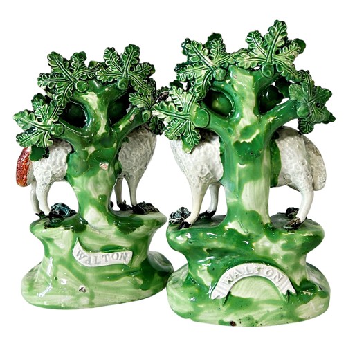 33 - A pair of late 18th century pearlware bocage groups, Ram and Ewe with lambs by Walton, 18cm high (2)