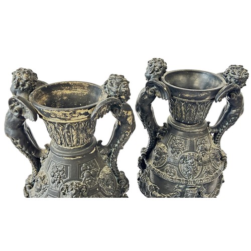 38 - A pair of large German pottery vases of classical form profusely decorated with character, mask and ... 