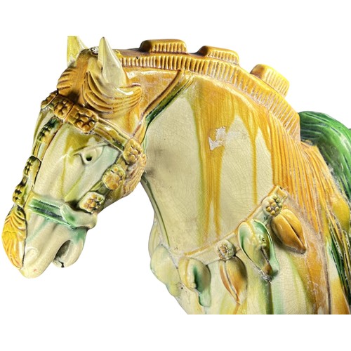 82 - A large Chinese earthenware Tang style horse decorated in sancai glazed finish (af)