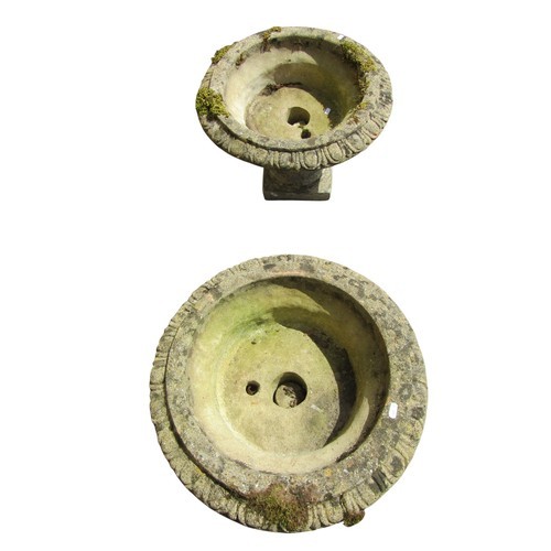 1006 - A pair of weathered composition stone pedestal garden urns, each with egg and dart moulded borders a... 