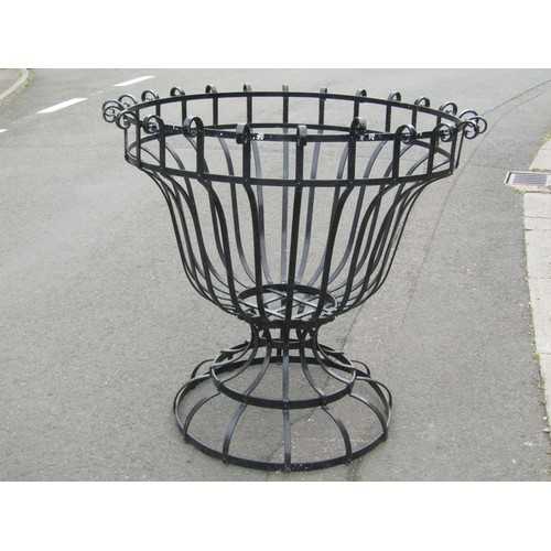 1047 - A large open strapwork planter of circular tapered form with simple repeating scroll detail, 111 cm ... 