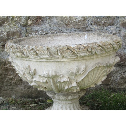 1059 - A pair of weathered cast composition stone garden urns and loose socles with acanthus detail, 48 cm ... 