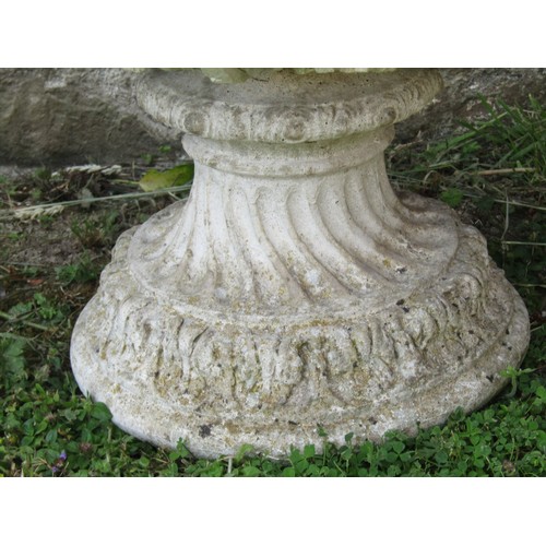 1059 - A pair of weathered cast composition stone garden urns and loose socles with acanthus detail, 48 cm ... 