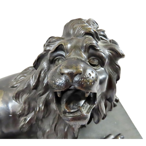 54 - A large 18th century continental cast bronze model of a recumbent lion, likely Italian, mounted on a... 
