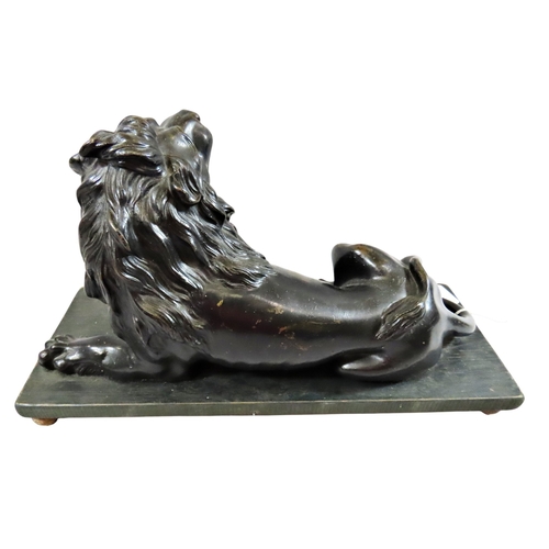 54 - A large 18th century continental cast bronze model of a recumbent lion, likely Italian, mounted on a... 