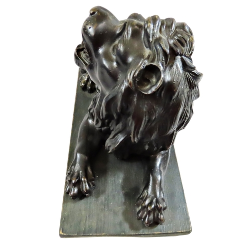 54 - A large 18th century continental cast bronze model of a recumbent lion, likely Italian, mounted on a... 