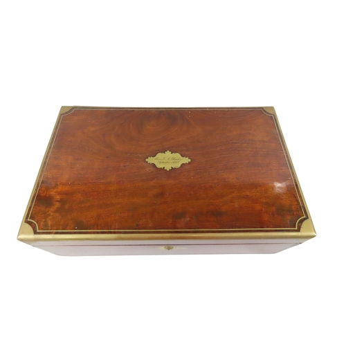 23 - A good William IV mahogany writing slope, with brass banded borders and corners, flanked with flush-... 