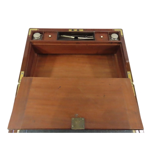23 - A good William IV mahogany writing slope, with brass banded borders and corners, flanked with flush-... 