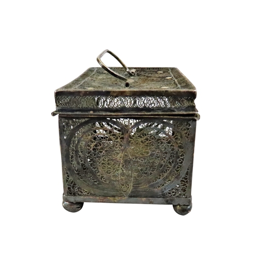 6 - An early continental filigree white metal / silver casket, the hinged cover with swing handle, raise... 