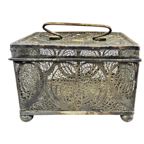 6 - An early continental filigree white metal / silver casket, the hinged cover with swing handle, raise... 