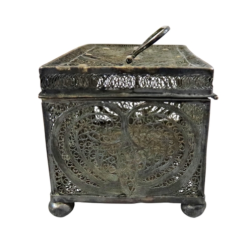 6 - An early continental filigree white metal / silver casket, the hinged cover with swing handle, raise... 
