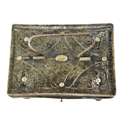 6 - An early continental filigree white metal / silver casket, the hinged cover with swing handle, raise... 