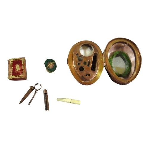 11 - A French natural walnut miniature sewing etui for a child or doll, gilt hinge mount, the lid interio... 