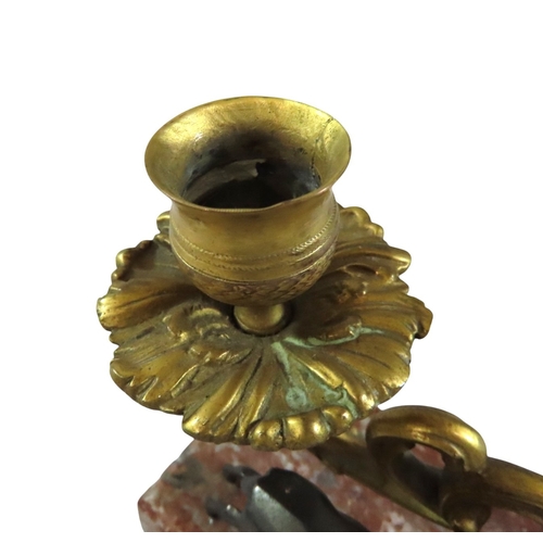 13 - A pair of 19th century continental bronze and ormolu candlesticks, decorated with opposing stags bes... 