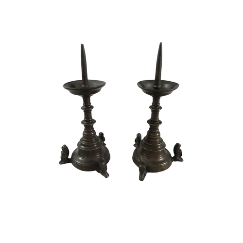 52 - A good pair of early continental ecclesiastical cast bronze pricket candlesticks, with flared bowls ... 