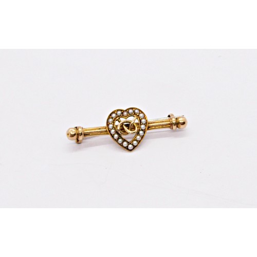 287 - A Victorian 15ct yellow gold bar brooch with loveheart motif bordered with pearls, centred with an e... 