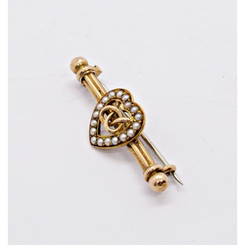 287 - A Victorian 15ct yellow gold bar brooch with loveheart motif bordered with pearls, centred with an e... 