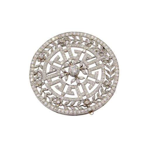A fine and impressive Art Deco/Belle Époque diamond pendant/brooch, of open-worked circular form, set throughout with rose and old-cut diamonds, millegrain accents, the central diamond weighing approximately 0.50ct, in unmarked white metal with detachable pendant and hinged brooch fittings, 45mm wide approximately, 22.4 grams in total, accompanied by an associated Tooled leather jeweller’s box, ‘Jay’s 56, King’s Road, Brighton