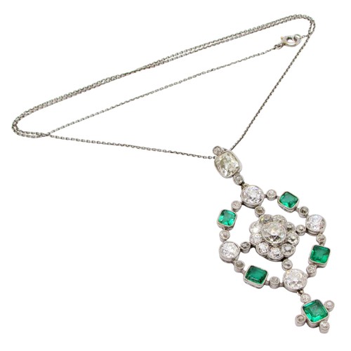 290 - A fine Edwardian diamond and emerald pendant, of open-worked circular form, the central diamond 0.78... 