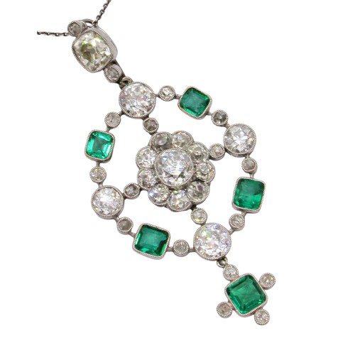 290 - A fine Edwardian diamond and emerald pendant, of open-worked circular form, the central diamond 0.78... 