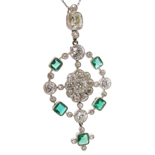 290 - A fine Edwardian diamond and emerald pendant, of open-worked circular form, the central diamond 0.78... 