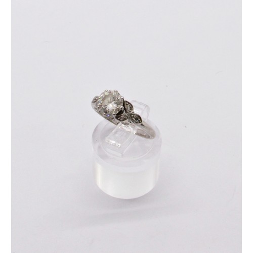 311 - A diamond ring, claw set with a round brilliant cut diamond, approx 1.04ct, with diamond-set foliate... 