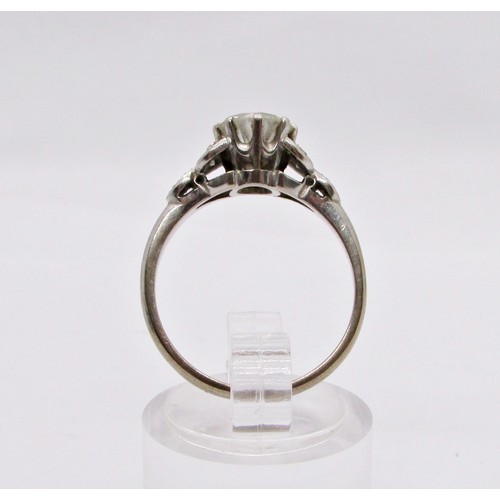 311 - A diamond ring, claw set with a round brilliant cut diamond, approx 1.04ct, with diamond-set foliate... 