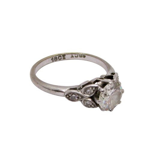 311 - A diamond ring, claw set with a round brilliant cut diamond, approx 1.04ct, with diamond-set foliate... 