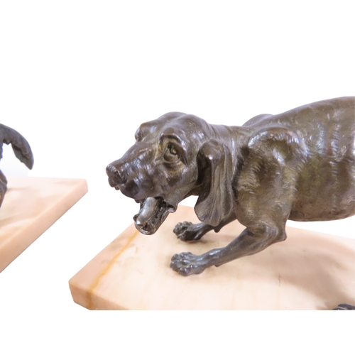 51 - A pair of 19th century French bronze animalier models of opposing dogs, with well patinated finish t... 