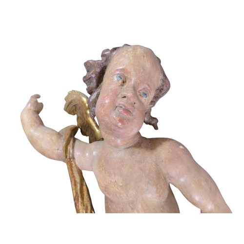 37 - A large and impressive associated pair of carved and painted limewood putti, likely south German / N... 