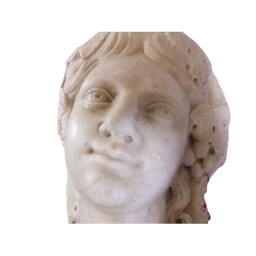 42 - A well carved antique white marble relief bust, study of a maiden, her hair in ringlets and adored w... 
